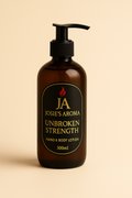 Brown lotion bottle with black pump labeled 'Josie's Aroma Unbroken Strength' on a beige background